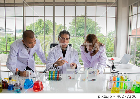 Blurred young woman and two man scientists  46277206