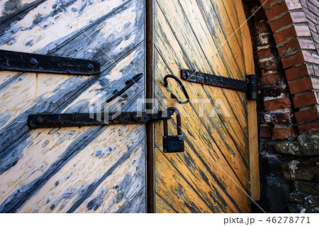 Gate of an old barracks with a pendant lock Gate of an old barracks with a pendant lock 46278771