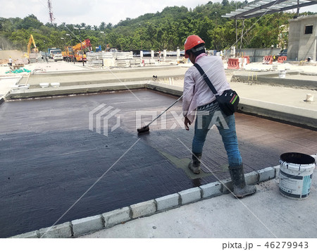 Waterproofing membrane applied by workers Waterproofing membrane applied by workers 46279943