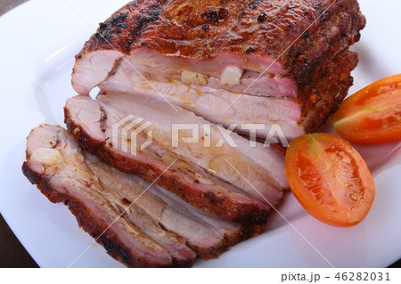 grilled pork chops with tomato and ketchup on plate. grilled pork chops with tomato and ketchup on plate. 46282031