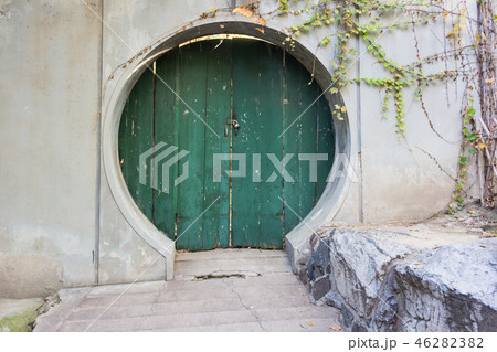 Round green fantasy door in the wall 46282382