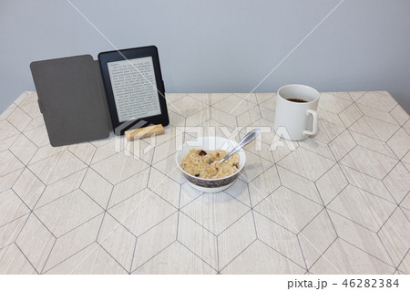 Electronic book and a cup of coffee on the table 46282384