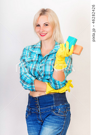 Happy housekeeper demonstrate sponges for washing 46282426