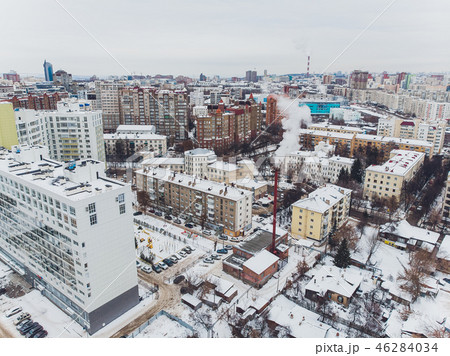 Snow covered city town and village houses in daylight with fresh snow and covered roofs. Snow covered city town and village houses in daylight with fresh snow and covered roofs. 46284034