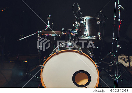 Modern drum set shot in smoky dark studio. 46284243