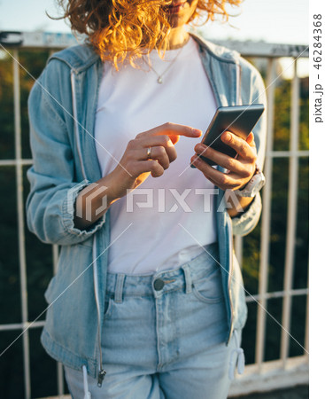 Happy young woman in blue jeans 46284368