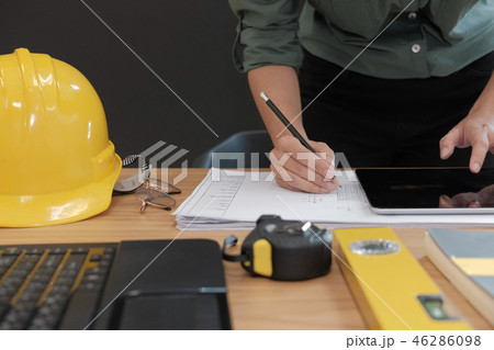 architect engineer working on house blueprint of real estate project at workplace. building construction concept 46286098