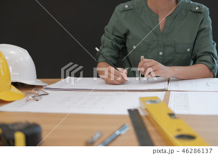 architect engineer working on house blueprint of real estate project at workplace. building construction concept architect engineer working on house blueprint of real estate project at workplace. building construction concept 46286137
