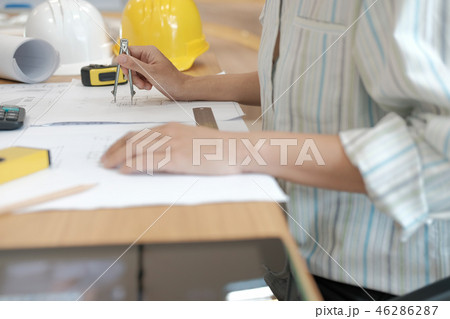 architect engineer working on house blueprint of real estate project at workplace. building construction concept 46286287