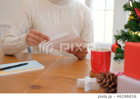 man opening sending christmas letter greeting card holiday wishes with xmas decoration 46286656