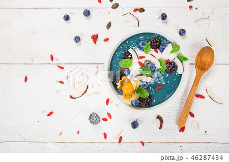 Smoothie bowl with fresh berries, nuts, seeds, fruit and vegetables. Smoothie bowl with fresh berries, nuts, seeds, fruit and vegetables. 46287434