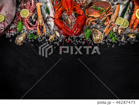 Fresh tasty seafood served on old wooden table. Fresh tasty seafood served on old wooden table. 46287475