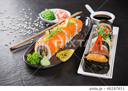 Japanese sushi set on a rustic dark background. Japanese sushi set on a rustic dark background. 46287651