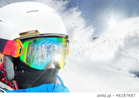 Skier skiing downhill in high mountains 46287687