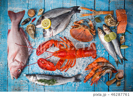 Fresh tasty seafood served on old wooden table. Fresh tasty seafood served on old wooden table. 46287761