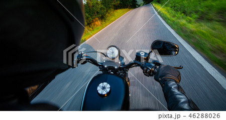 Man riding sportster motorcycle during sunset. 46288026