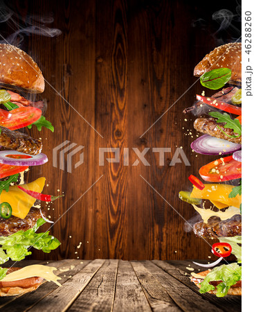 Big tasty burger with flying ingredients. 46288260