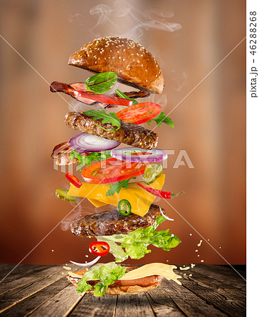 Big tasty burger with flying ingredients. 46288268