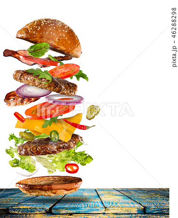 Big tasty burger with flying ingredients. Big tasty burger with flying ingredients. 46288298