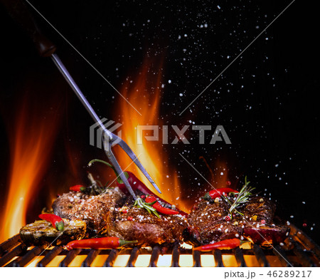 Beef steaks on the grill with flames Beef steaks on the grill with flames 46289217