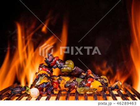 Tasty skewers on the grill with flames 46289463