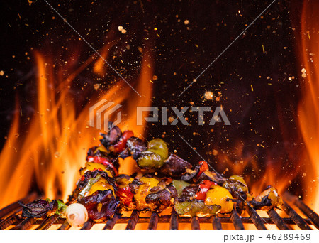 Chicken skewers on the grill with flames 46289469