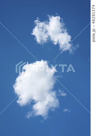 Two white clouds on blue sky Two white clouds on blue sky 46291374