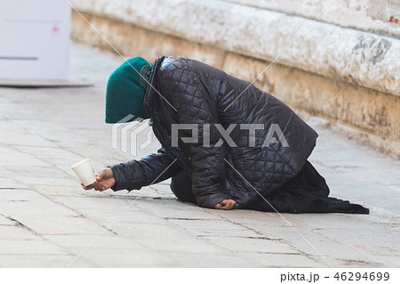 An old woman asks for help on the streets of Italy An old woman asks for help on the streets of Italy 46294699