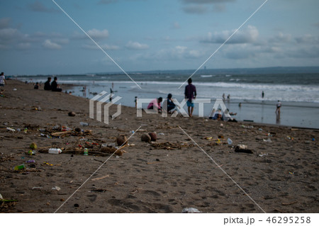 People seat near trash on the Beach, a lot of plastic garbide on the beach of Indian ocean People seat near trash on the Beach, a lot of plastic garbide on the beach of Indian ocean 46295258