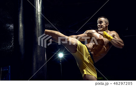 Thai boxer punch kick by punching bag 46297205