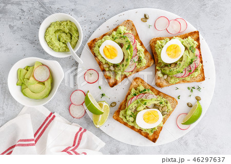 Toasts with avocado guacamole, radish, boiled egg 46297637