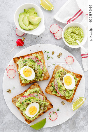 Toasts with avocado guacamole, radish, boiled egg 46297644