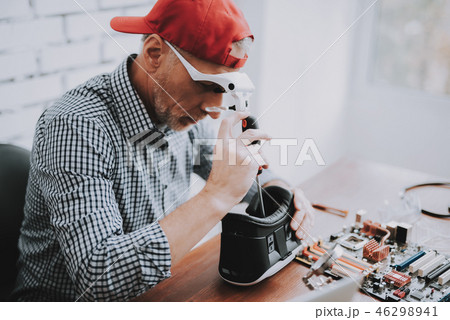 Bearded Old Man Repairing Motherboard from PC. 46298941