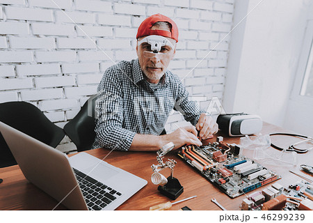 Bearded Old Man Repairing Motherboard from PC. Bearded Old Man Repairing Motherboard from PC. 46299239