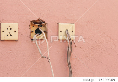 Old electricity socket and wires on cement wall. 46299369