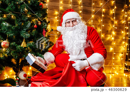 Santa Claus near Christmas tree with gifts. Christmas time 46300629
