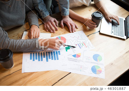 GRoup of students having a business lunch indoors analysing diagrams close-up 46301887