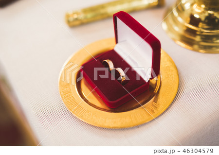 Two golden wedding rings isolated background concept 46304579