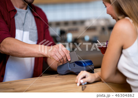 Paying by credit card in cafe Paying by credit card in cafe 46304862