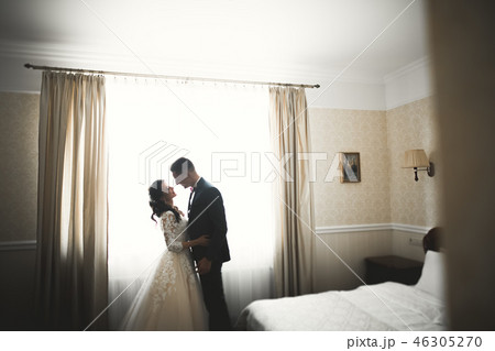 Cute happy bride and groom preparing for wedding Cute happy bride and groom preparing for wedding 46305270