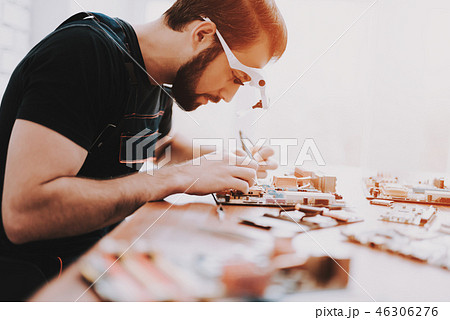 Young Bearded Man Repairing Motherboard from PC. Young Bearded Man Repairing Motherboard from PC. 46306276