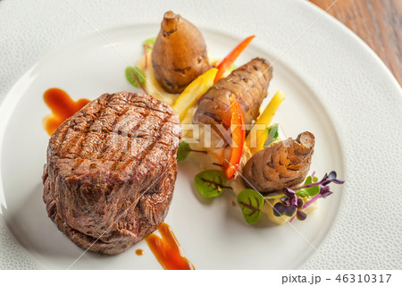 delicious beef steak with sauce and vegetable 46310317