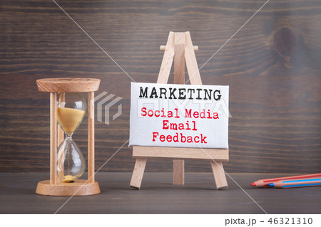 Marketing Strategy concept. Sandglass, hourglass or egg timer on wooden table Marketing Strategy concept. Sandglass, hourglass or egg timer on wooden table 46321310