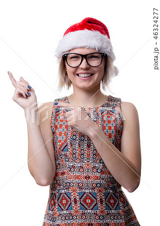 Image of blonde in glasses and santa cap showing finger on empty space Image of blonde in glasses and santa cap showing finger on empty space 46324277