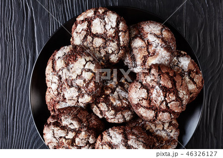 Chocolate Crinkle cookies on black plate, close-up 46326127