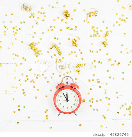 New Year composition alarm clock golden confetti 46326746