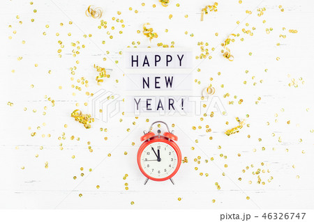 New Year composition alarm clock golden confetti 46326747