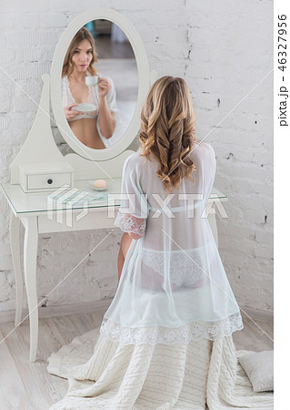Gentle girl in elegant lingerie in front of the mirror 46327956