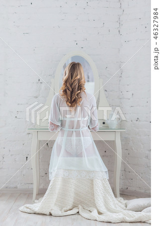 Gentlebride in negligee prepare for the wedding. 46327984