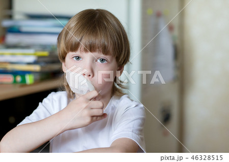 child sits with mouth sealed tape 46328515